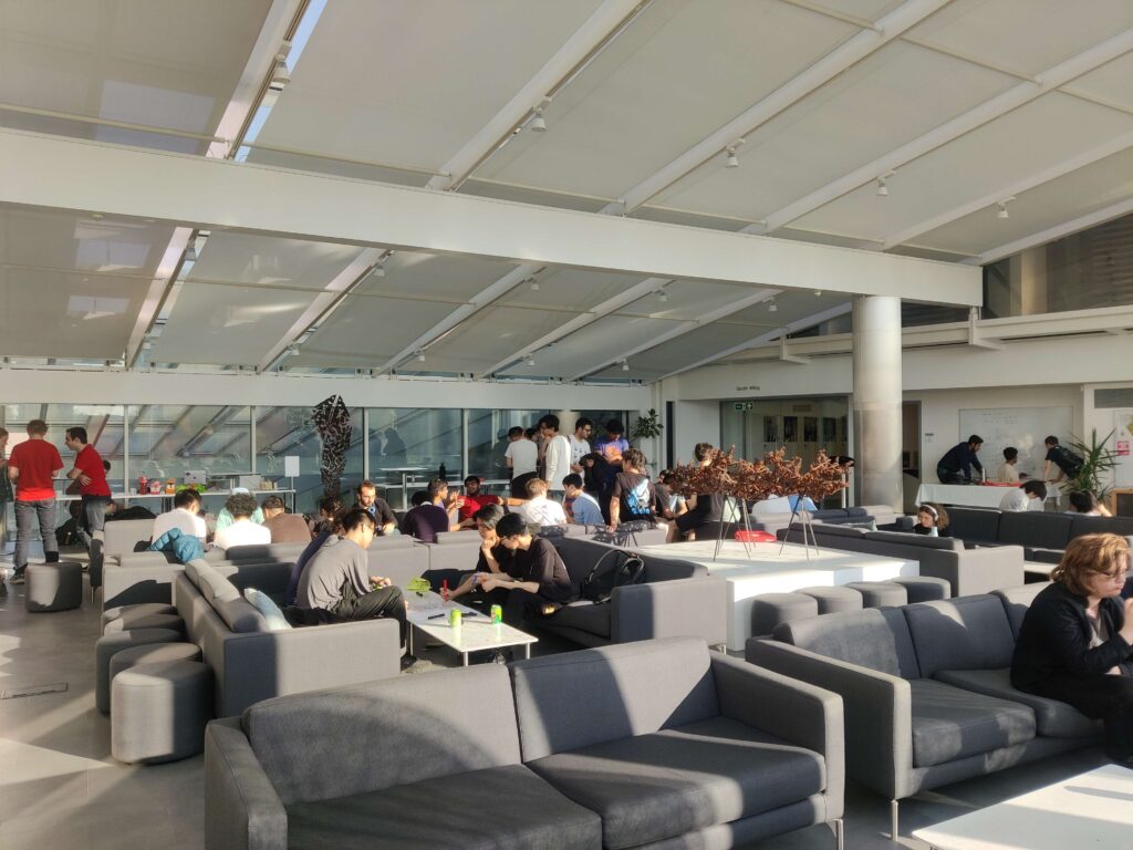 People in the Andrew Wiles Building's Common Room, chatting together at a social event